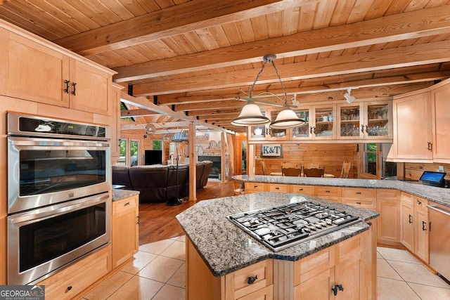 kitchen featuring light tile patterned floors, appliances with stainless steel finishes, and light brown cabinetry