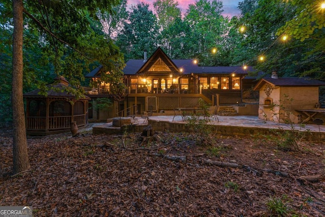 back of house with a patio, a wooden deck, a gazebo, and stairs