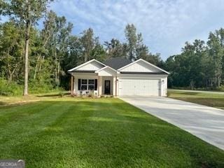 view of front facade with a garage, driveway, and a front lawn