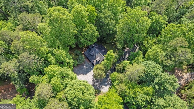 drone / aerial view featuring a view of trees