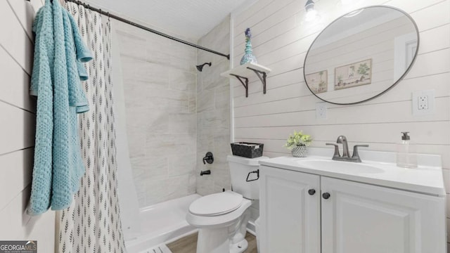 bathroom with toilet, a shower stall, and vanity