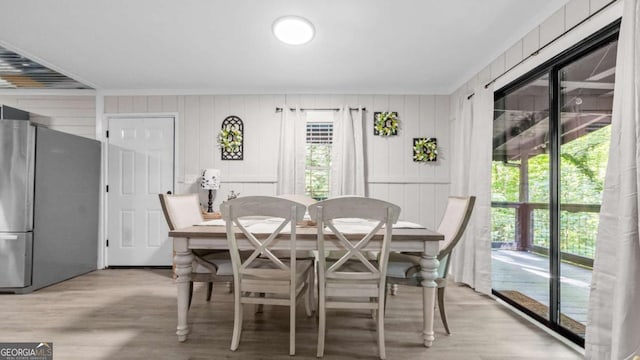 dining area with light wood-style floors and plenty of natural light