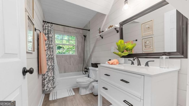 bathroom featuring toilet, shower / tub combo, wood finished floors, and vanity