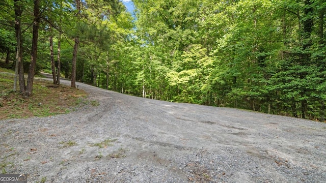 view of street featuring a forest view