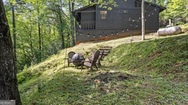 view of yard with an outdoor fire pit