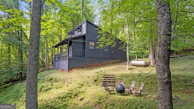 view of home's exterior featuring an outdoor fire pit