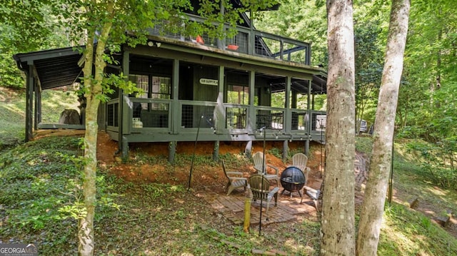 back of house featuring a fire pit