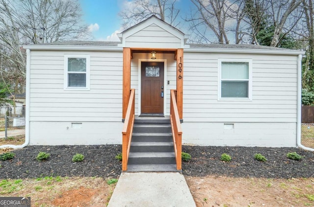 bungalow-style house with crawl space and fence