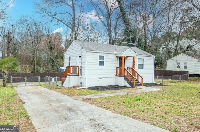 view of front of home with crawl space, a front yard, fence, and a gate