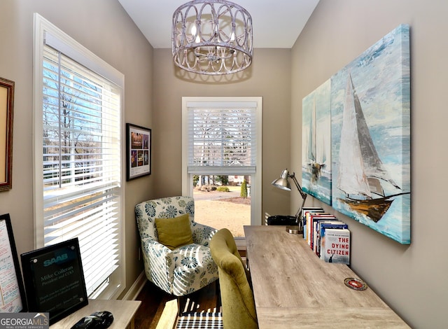 living area with a chandelier and wood finished floors