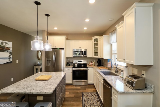 kitchen with recessed lighting, appliances with stainless steel finishes, dark wood-type flooring, white cabinetry, and a sink