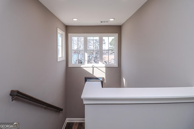 stairs with recessed lighting, wood finished floors, visible vents, and baseboards