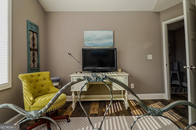 office area with baseboards and wood finished floors