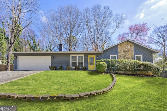 view of front of property featuring an attached garage, stone siding, driveway, and a front yard