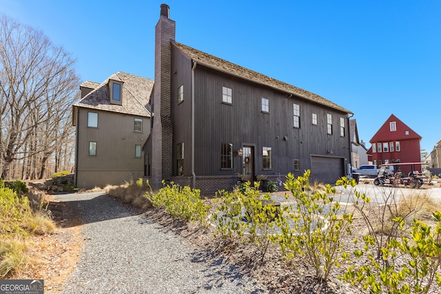 back of house with a chimney