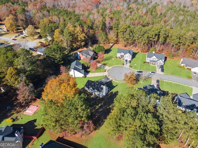 birds eye view of property featuring a forest view and a residential view