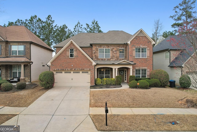 view of front of property featuring brick siding, concrete driveway, a garage, and a shingled roof