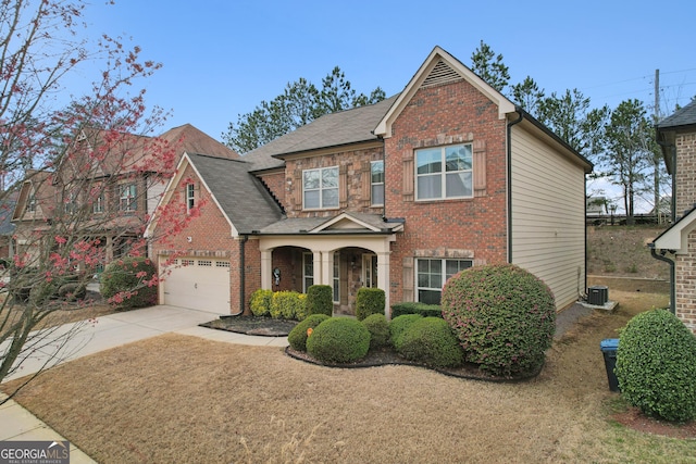 view of front facade with brick siding, a shingled roof, central AC, a garage, and driveway