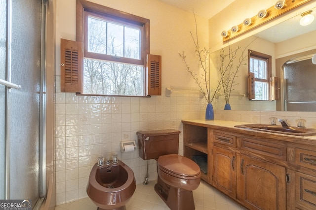 full bathroom with a stall shower, a bidet, tile walls, and vanity