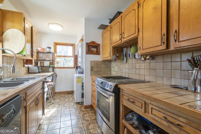 kitchen featuring tile countertops, electric range, baseboards, decorative backsplash, and dishwasher