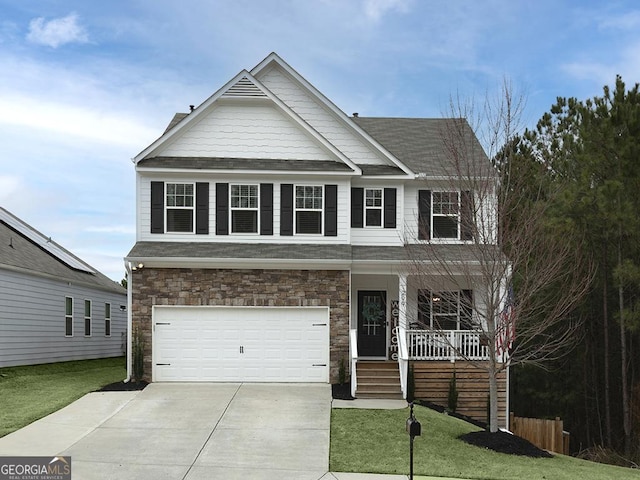 view of front of house featuring a porch, concrete driveway, a front lawn, a garage, and stone siding