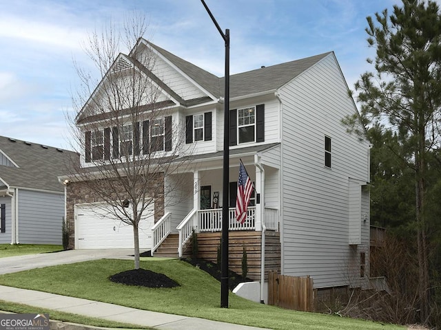 view of front of property featuring a porch, a garage, a front yard, and driveway