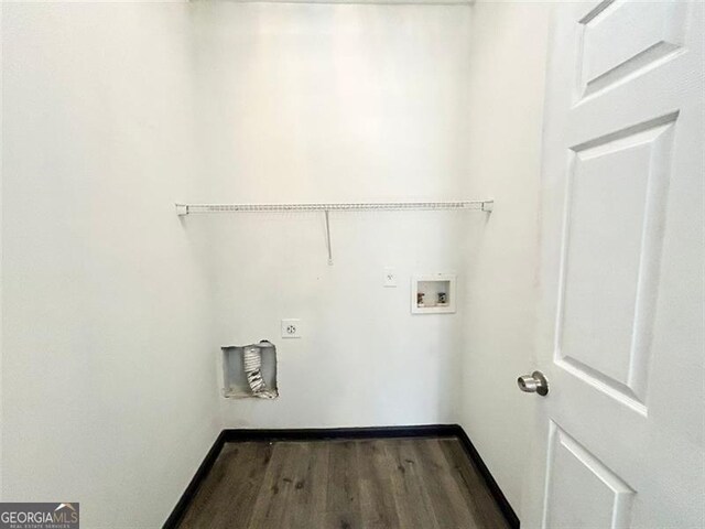 clothes washing area featuring hookup for a washing machine, electric dryer hookup, wood finished floors, laundry area, and baseboards