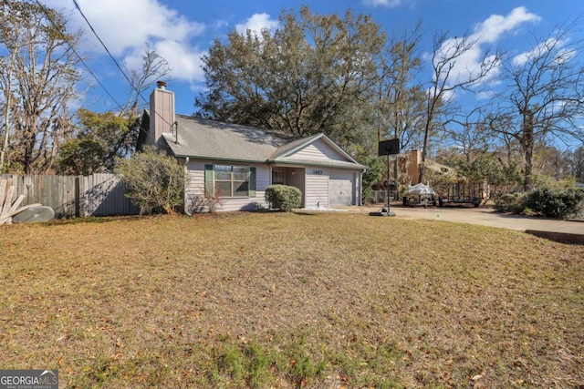 ranch-style house with a garage, concrete driveway, a chimney, fence, and a front lawn