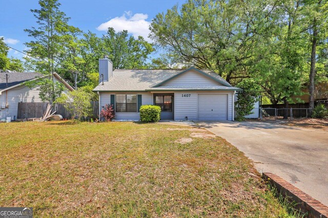 1407 Forest Lake Dr, Hinesville, GA 31313 - single story home with an attached garage, fence, driveway, and a front lawn