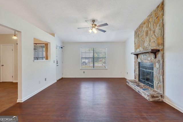 1407 Forest Lake Dr, Hinesville, GA 31313 - unfurnished living room featuring a fireplace, wood finished floors, a textured ceiling, and a ceiling fan