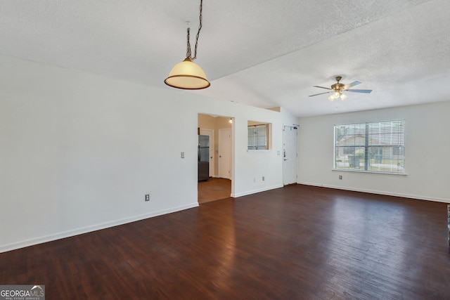 1407 Forest Lake Dr, Hinesville, GA 31313 - unfurnished living room featuring ceiling fan, baseboards, wood finished floors, and a textured ceiling