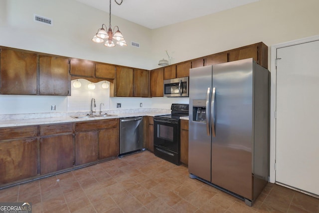 1407 Forest Lake Dr, Hinesville, GA 31313 - kitchen with a sink, visible vents, an inviting chandelier, light countertops, and appliances with stainless steel finishes