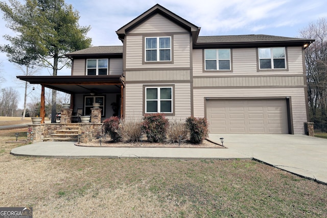 view of front facade with an attached garage, concrete driveway, and a front yard