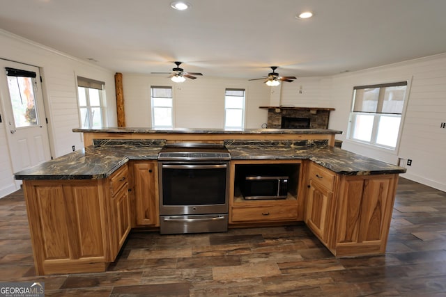 kitchen featuring dark wood finished floors, plenty of natural light, and appliances with stainless steel finishes