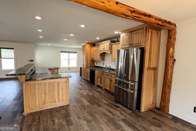 kitchen featuring a breakfast bar, freestanding refrigerator, a sink, dark wood-type flooring, and black dishwasher