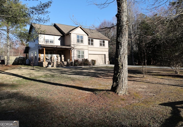 traditional home featuring an attached garage and dirt driveway