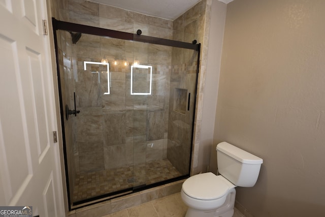 full bathroom featuring a shower stall and toilet