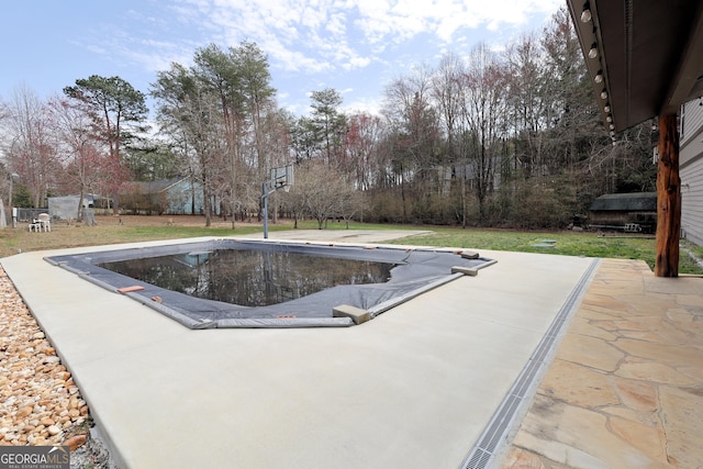 view of swimming pool featuring a yard and a patio