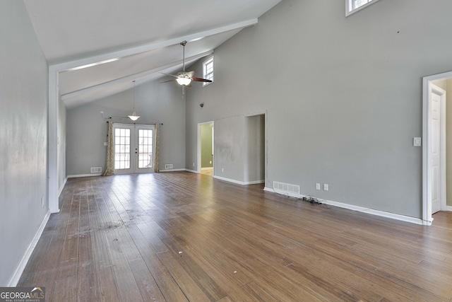 unfurnished living room featuring ceiling fan, visible vents, french doors, beamed ceiling, and wood-type flooring