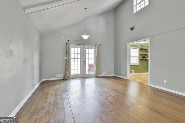 unfurnished room featuring french doors, wood-type flooring, visible vents, and baseboards