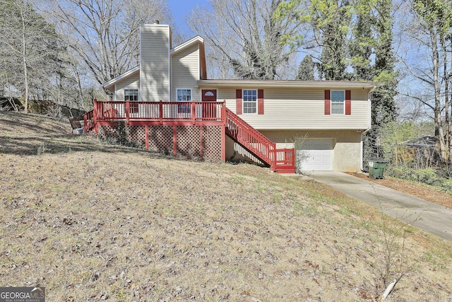 view of front of property with a garage, driveway, stairway, stucco siding, and a chimney