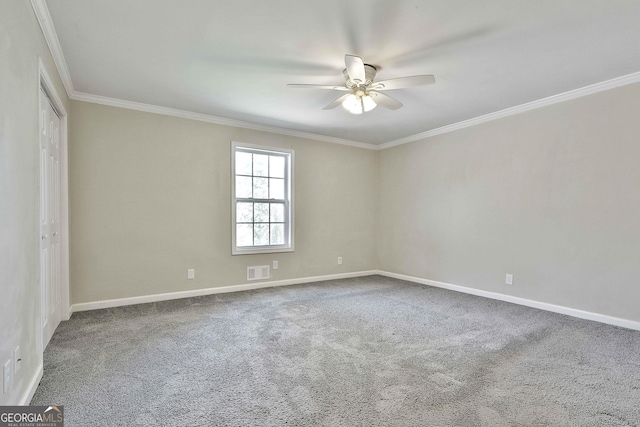 empty room featuring baseboards, visible vents, ceiling fan, crown molding, and carpet floors