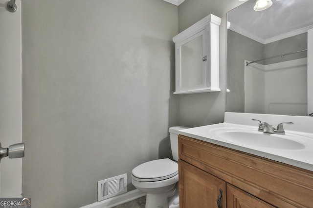 bathroom with toilet, ornamental molding, vanity, and visible vents