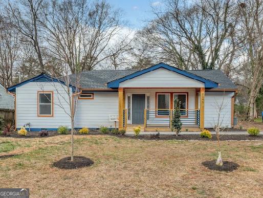 ranch-style home with a porch and a front yard