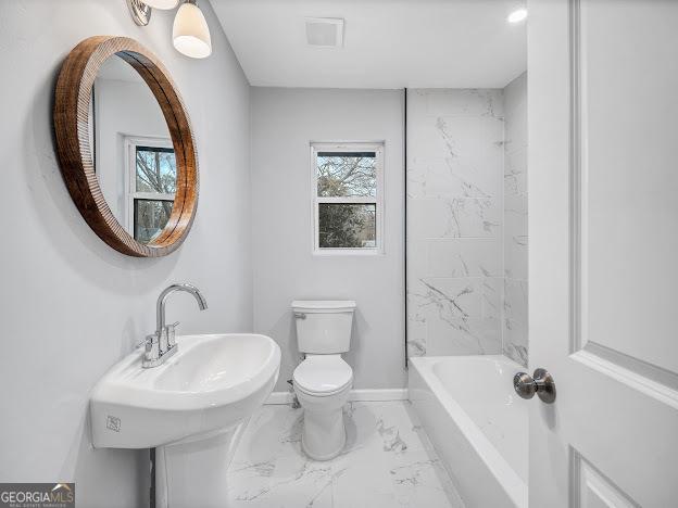 full bathroom featuring marble finish floor, toilet, baseboards, and a sink