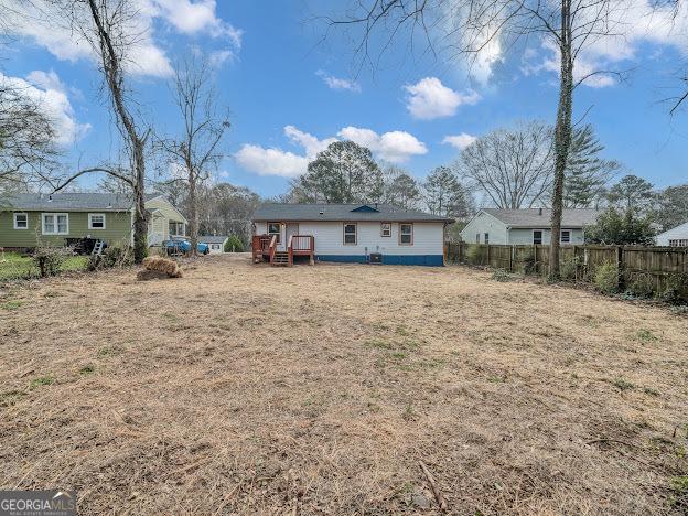 back of house with fence