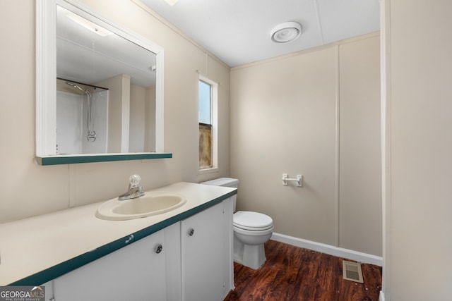 full bath with visible vents, vanity, toilet, and wood finished floors