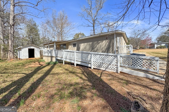 view of home's exterior featuring a shed, a deck, a lawn, and an outbuilding