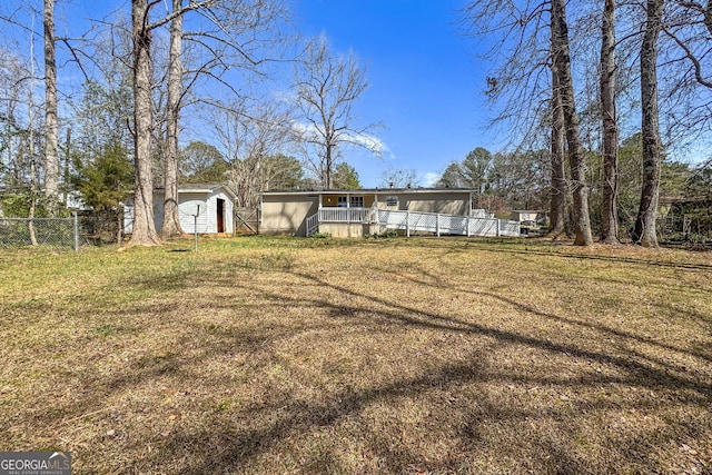 back of property with fence and a lawn