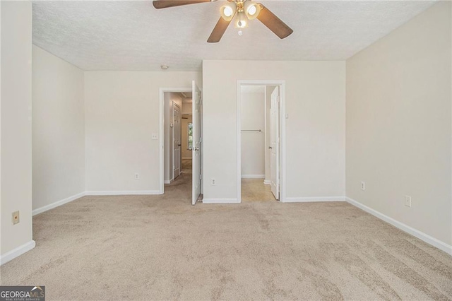 unfurnished bedroom featuring carpet, baseboards, and a textured ceiling